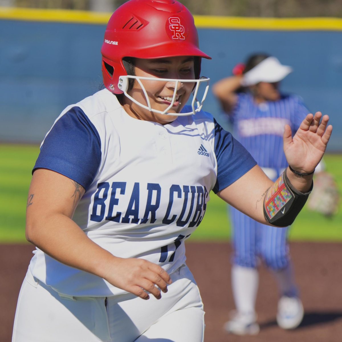 Gabriela Schenone reaches for a high five after securing third base against West Hills Coalinga at Santa Rosa's Marv Mayes Field Feb. 10, 2024.