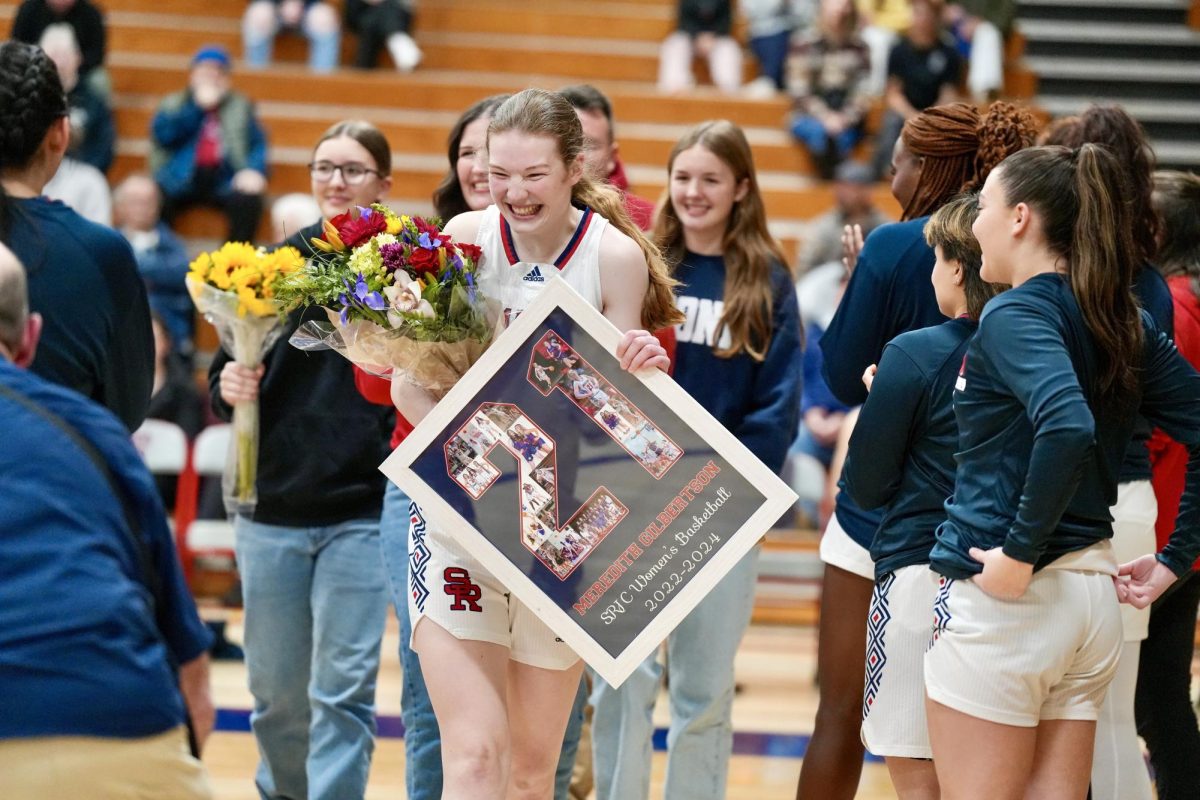 Meredith Gilbertson is greeted with a custom frame and bouquets of flowers during Sophomore Night at Santa Rosa’s Haehl Pavilion Feb. 20, 2024.