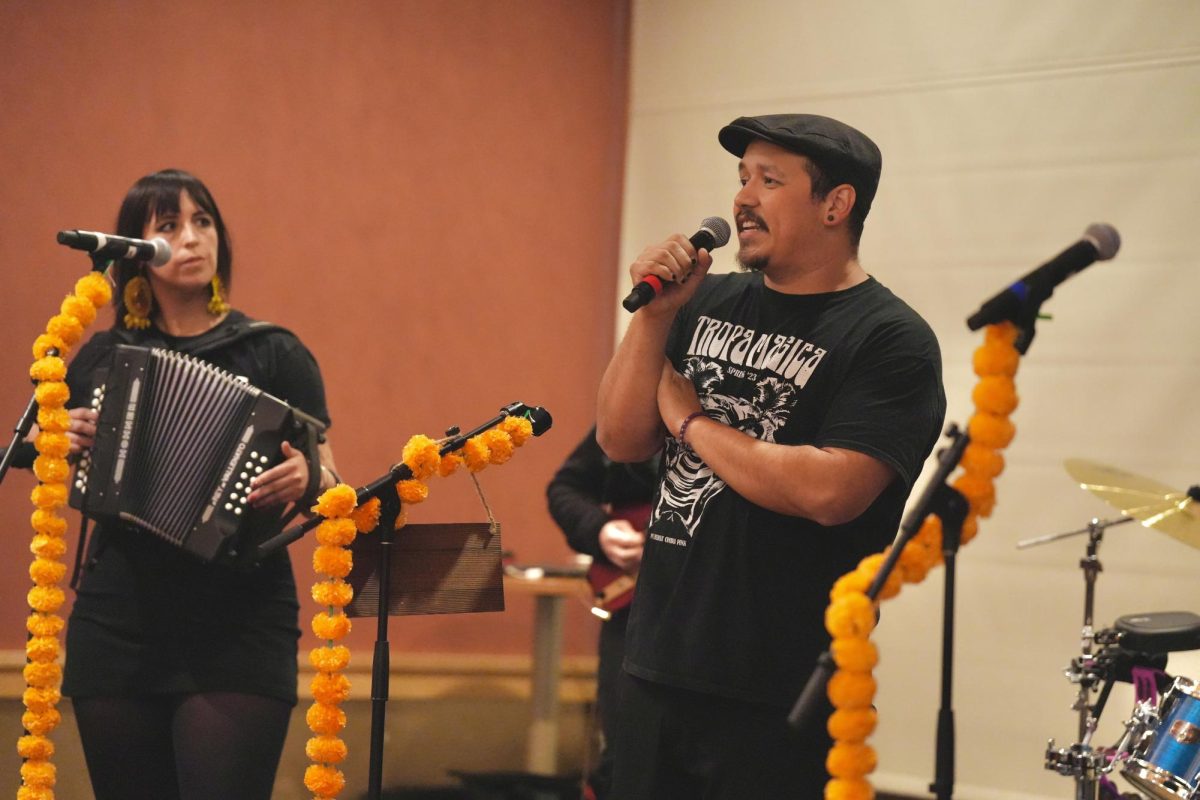 Microphone stands are intricately adorned with marigolds to prepare for the band Rasquaches’ opening act for spoken word artist BocaFloja at the Santa Rosa Junior College Bertolini Student Services Center Feb. 9, 2024.