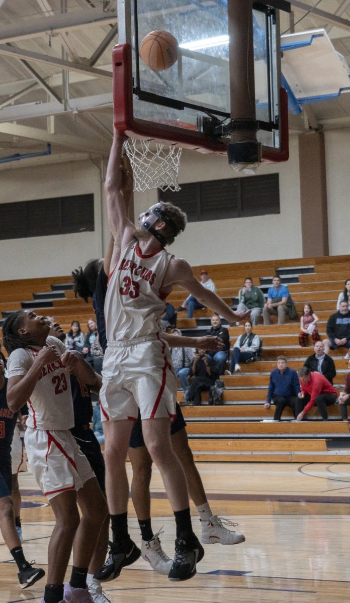 SRJC forward Justin Smith meets another CRC player at the rim as they fight over the ball at Haehl Pavillion on Feb. 6, 2024