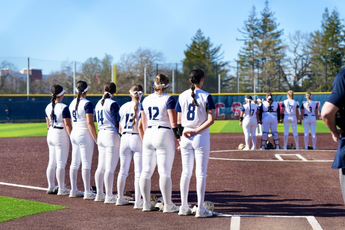 Members of the softball team stand ready during the national anthem as they face American River College at Santa Rosa’s Marv Mayes Field Feb. 27, 2024.