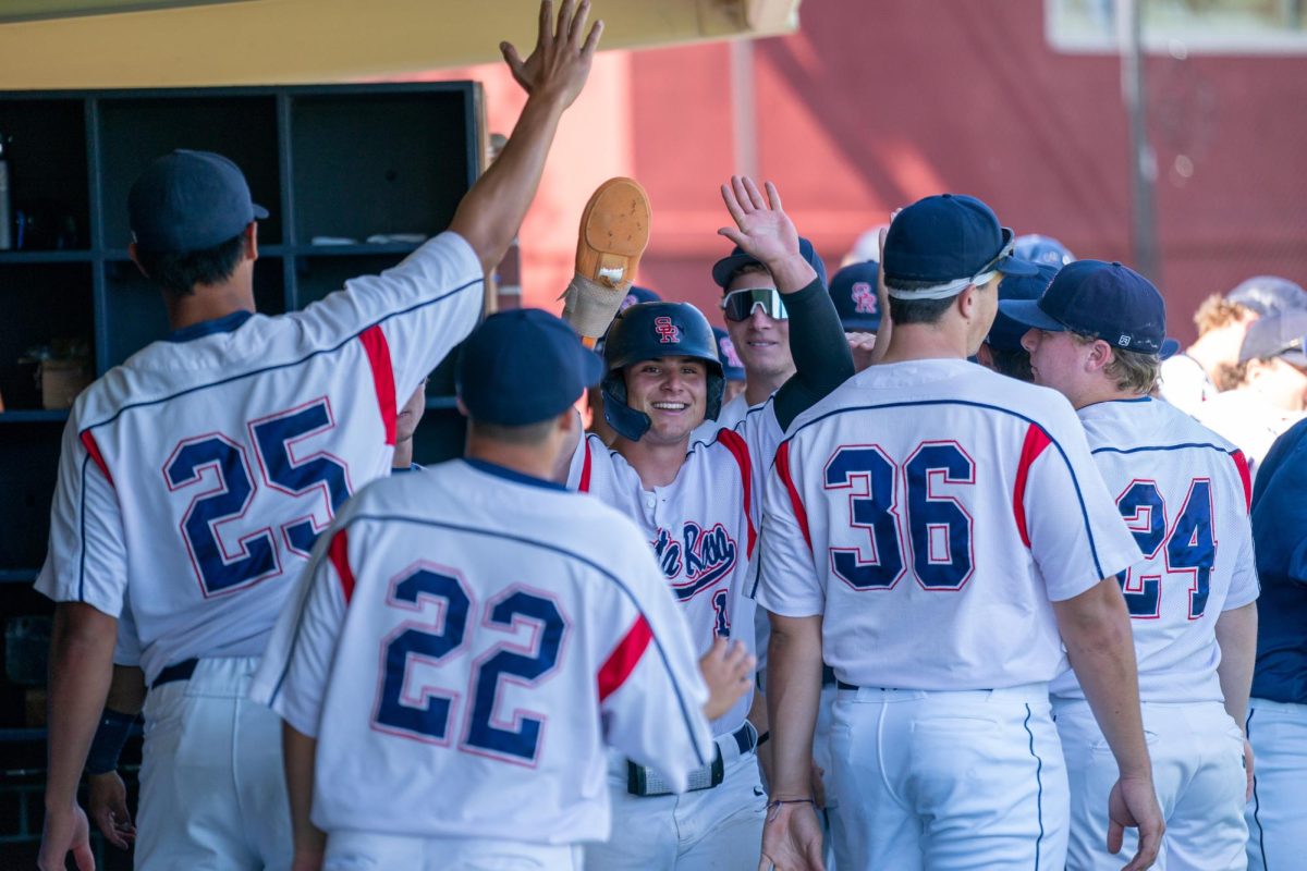 Bear Cubs outfielder Alex Leopard, middle, is greeted with cheers in the dugout after being knocked in by first baseman Josh Martin against Cosumnes River College on Tuesday, March 26, 2024 in Santa Rosa. 