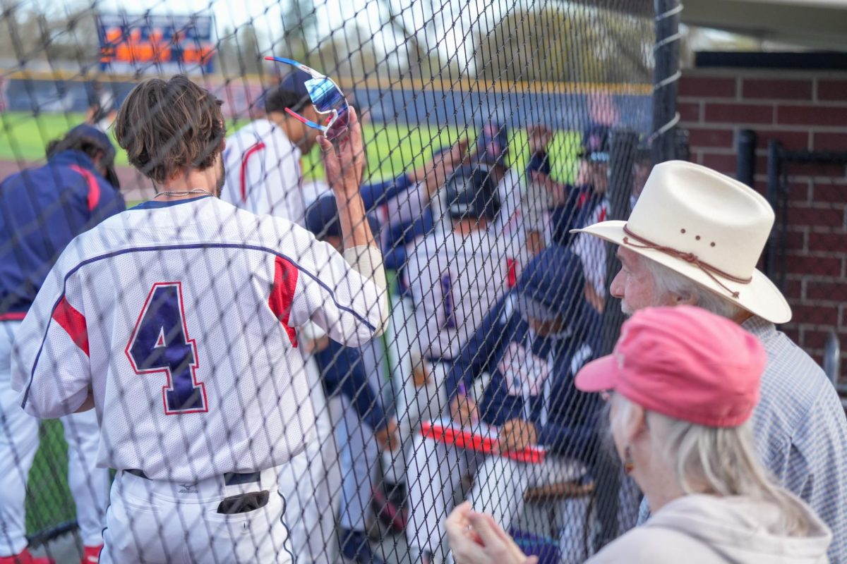 Catcher Cameron Duran raises his glasses up and spectators look on after Alex Leopard hits a three-run home run in the bottom of the eighth inning against Cosumnes River College at Santa Rosa's Cook Syper Field, March 26, 2024.