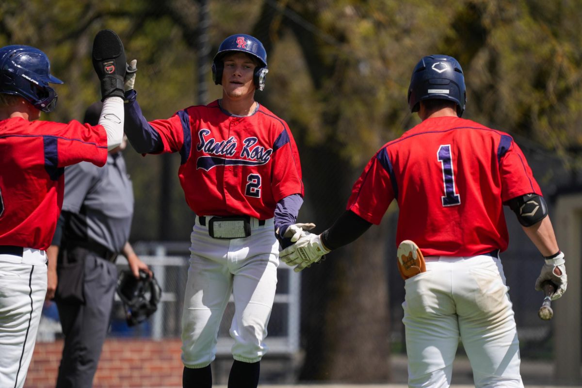 Quinn Medin scores on Lombardis single to left field in the bottom of the fifth inning and is greeted with praise at home plate from his other teammates against Cosumnes River College at Santa Rosas Cook Sypher Field on Saturday, March 30, 2024. 