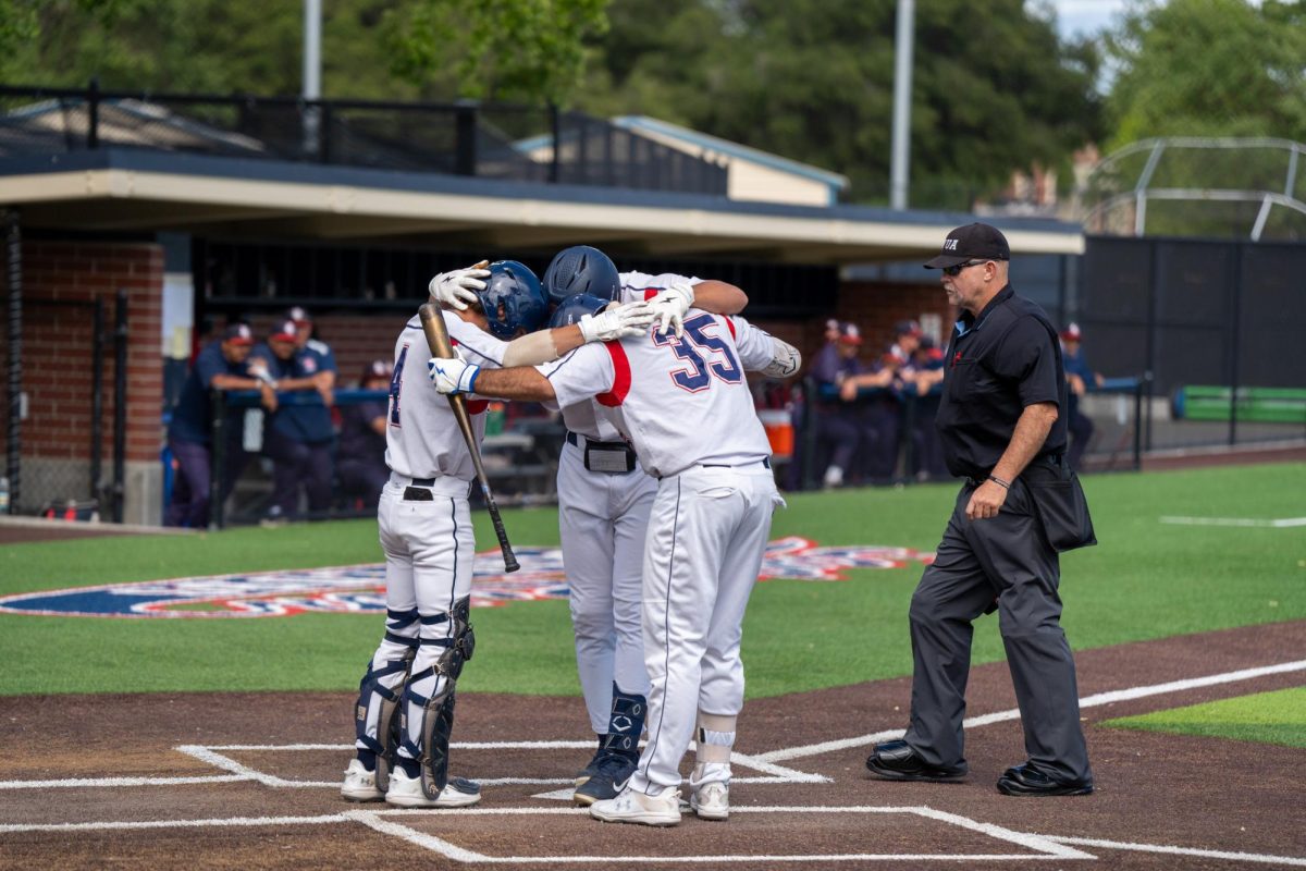 Cameron Duran and Josh Martin huddle up with Zane Bennett in celebration of Bennett's solo home run in the bottom of the fifth against American River College at Santa Rosa's Cook Sypher Field on Thursday, April 25, 2024.