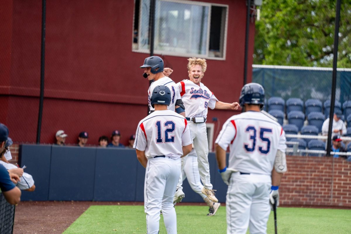 Alex Leopard and Keenan Morris leap up in the air after Leopard hits a home run in the bottom of the eighth to secure two more runs against American River College at Santa Rosa's Cook Sypher Field on Thursday, April 25, 2024.