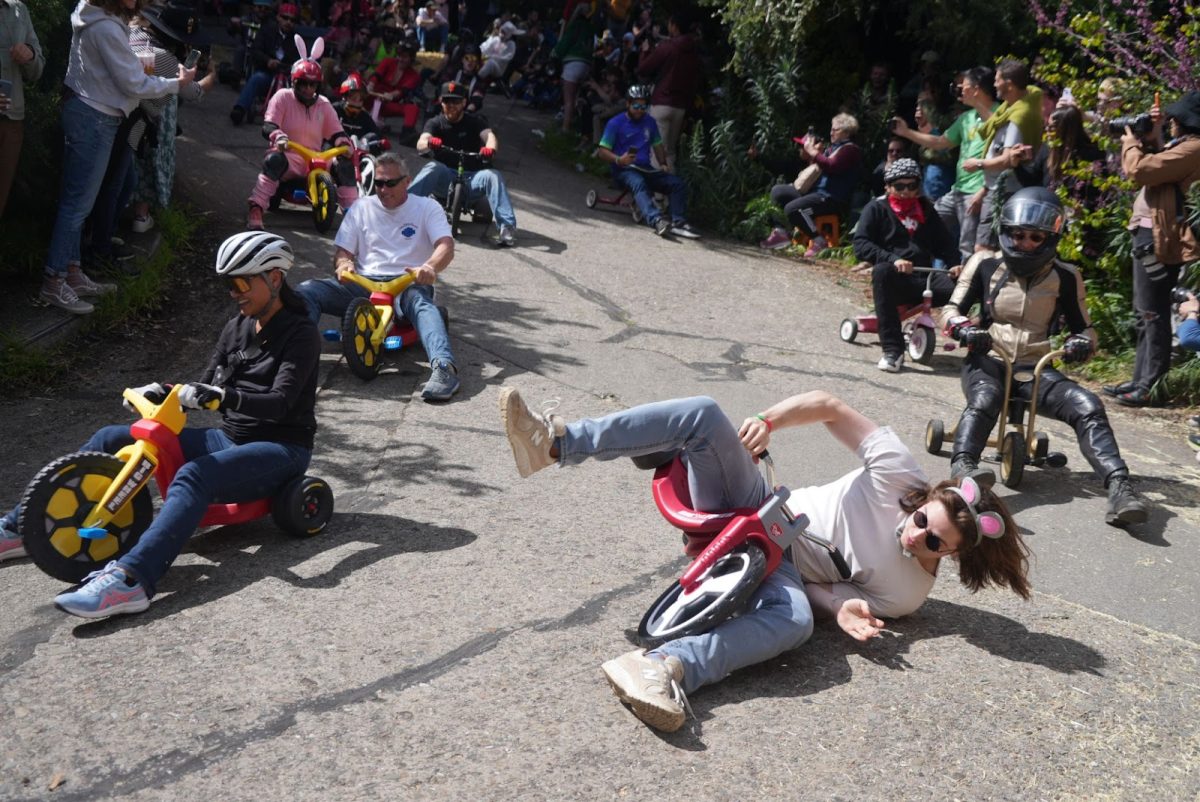 Big Wheel riders without brakes careen down Vermont Street on March 31, 2024 at San Francisco's annual Bring Your Own Big Wheel event. The inevitable collisions created scenes of total chaos.