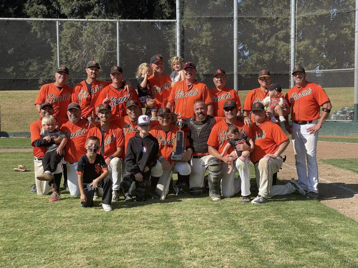 The 2023 35+ Giants celebrate a 19-2 season championship with their kids. Started in 1990, REBL has grown to 40 teams and brings families together at the ballpark on Sundays from spring to fall. 
