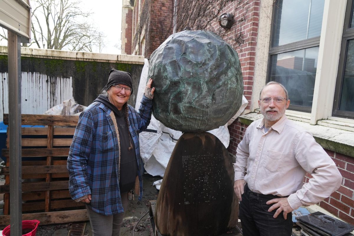Michael McGinnis and Laura Bacon stand in Analy Hall with the local artist Bruce Johnsons world-renowned sculpture, A Prayer For The Earth, which awaits restoration.  