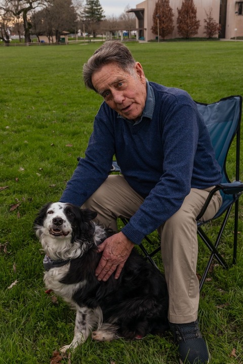 Michael Kenneth Beyries sits with his dog, Lily, whose company he will enjoy during his 6-month house arrest.