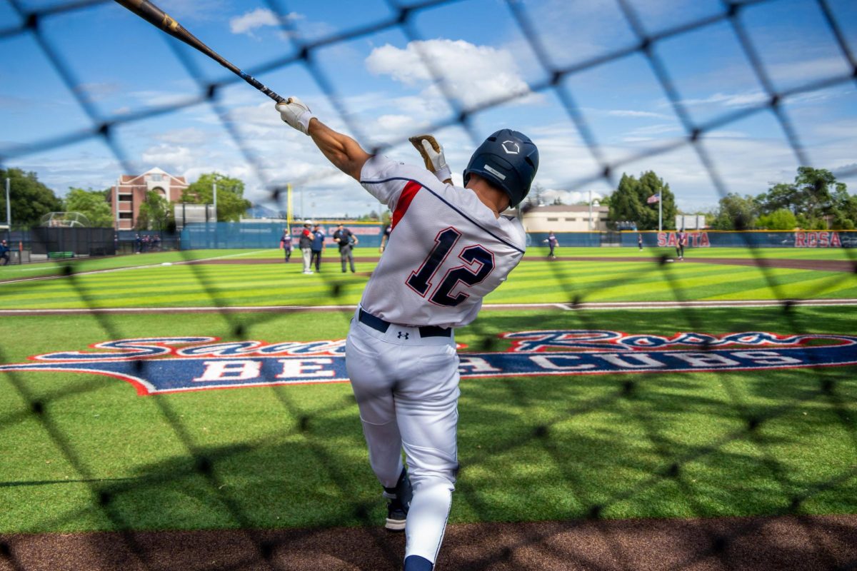 Outfielder Zane Bennett warms up near the dugout right before the game against American River College at Santa Rosa's Cook Sypher Field on Thursday, April 25, 2024.