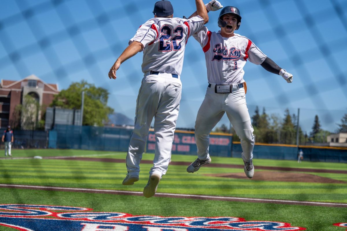 Alex Leopard, right, and Jacob Greiner celebrate near the dugout out after Leopard’s two-run home run in the bottom of the first inning against Modesto Junior College at Santa Rosa’s Cook Sypher Field on Thursday, April 11, 2024.