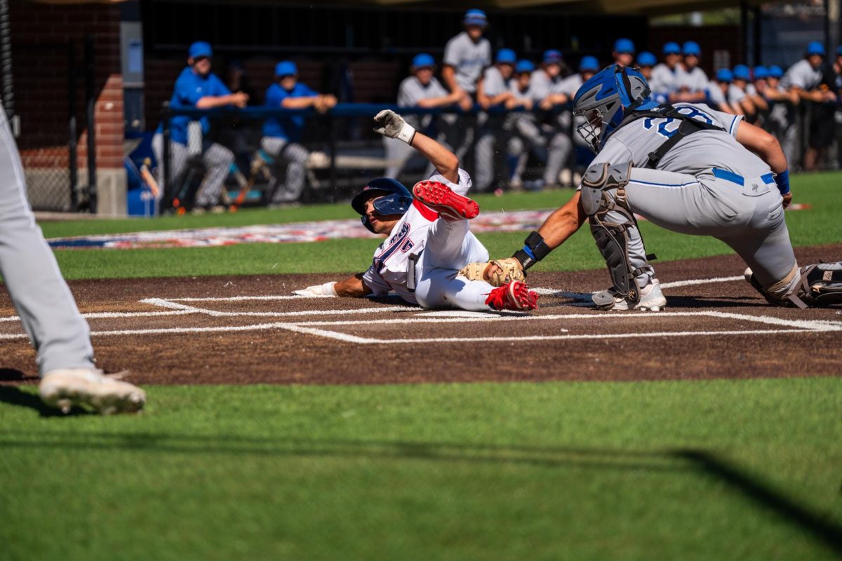 Second baseman Gabe Henschel is safe as he slides past Modesto's Carson Cripe after a single to right field advances him home at Santa Rosa’s Cook Sypher Field on Thursday, April 11, 2024.