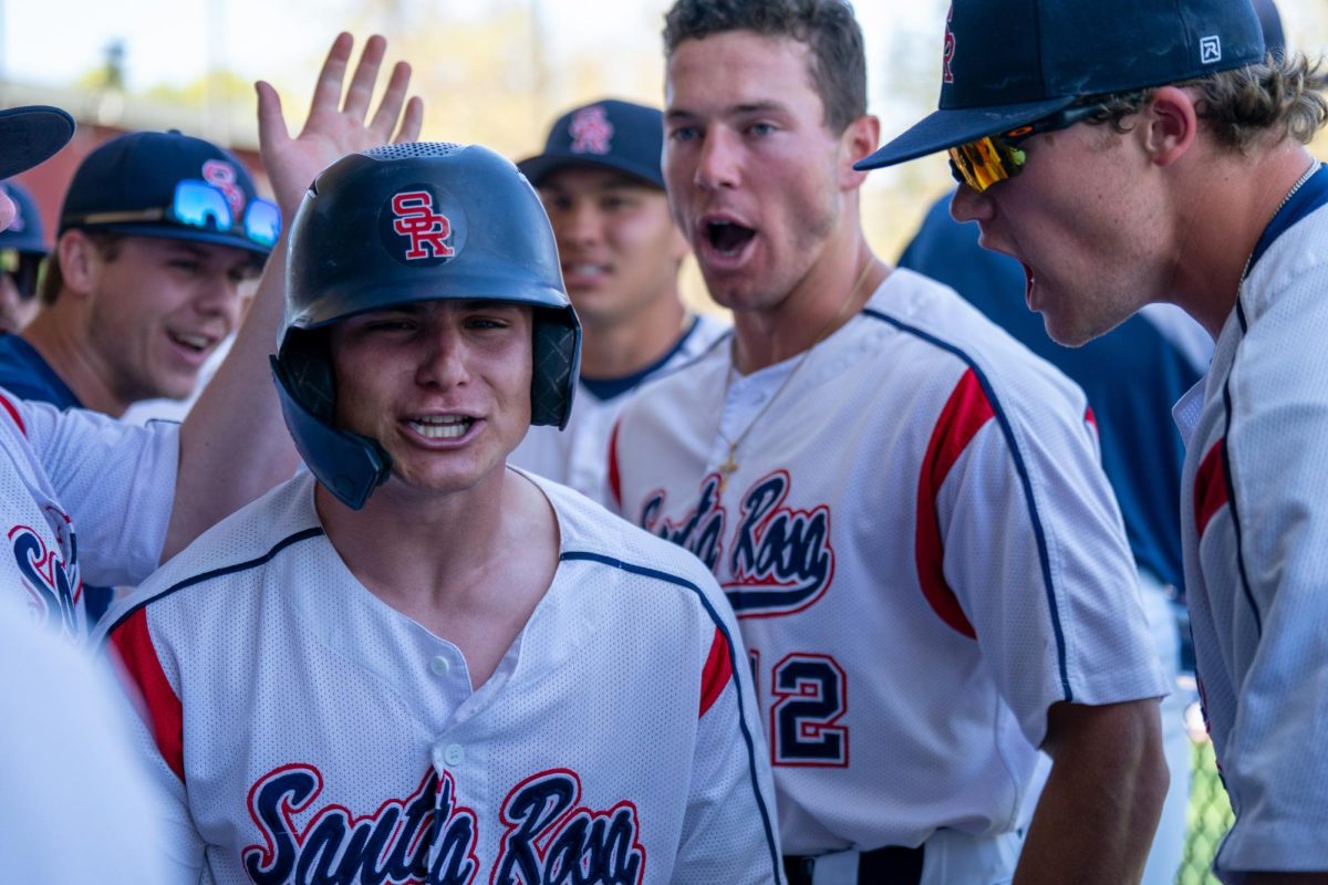 Bear Cubs Outfielder and pitcher Alex Leopard is surrounded in the dugout by his teammates in celebration after hitting a two-run home run on his birthday against San Joaquin Delta on Tuesday, April 2, 2024 in Santa Rosa.