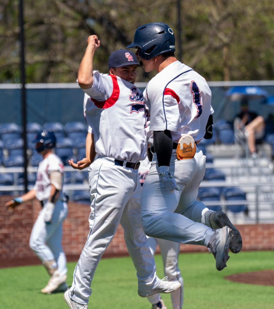 Alex Leopard, right, catches air with Jacob Greiner out after Leopard’s two-run home run in the bottom of the first inning against Modesto Junior College on Thursday, April 11, 2024 in Santa Rosa.