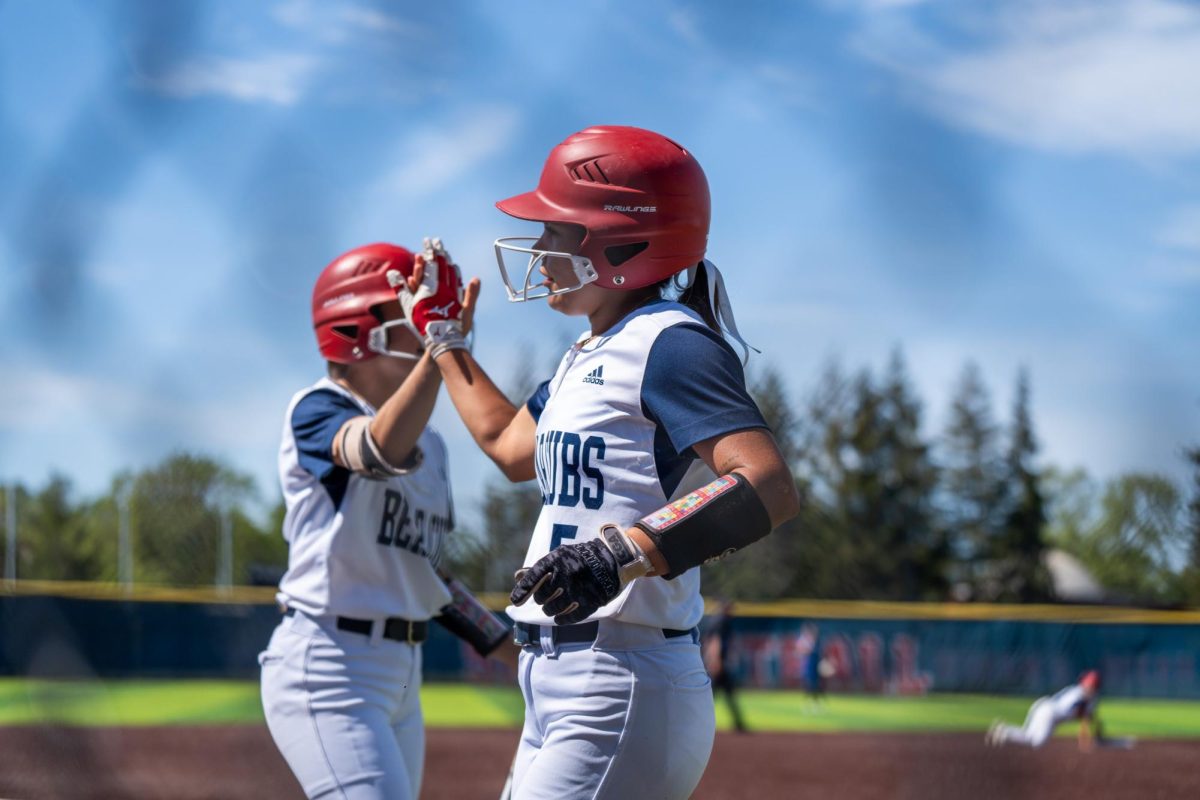 High fives all around as Nataya Brown scores from a single to right field to round out the bottom of the first inning against Modesto at Santa Rosa's Marv Mayes Field on Tuesday, April 16, 2024.