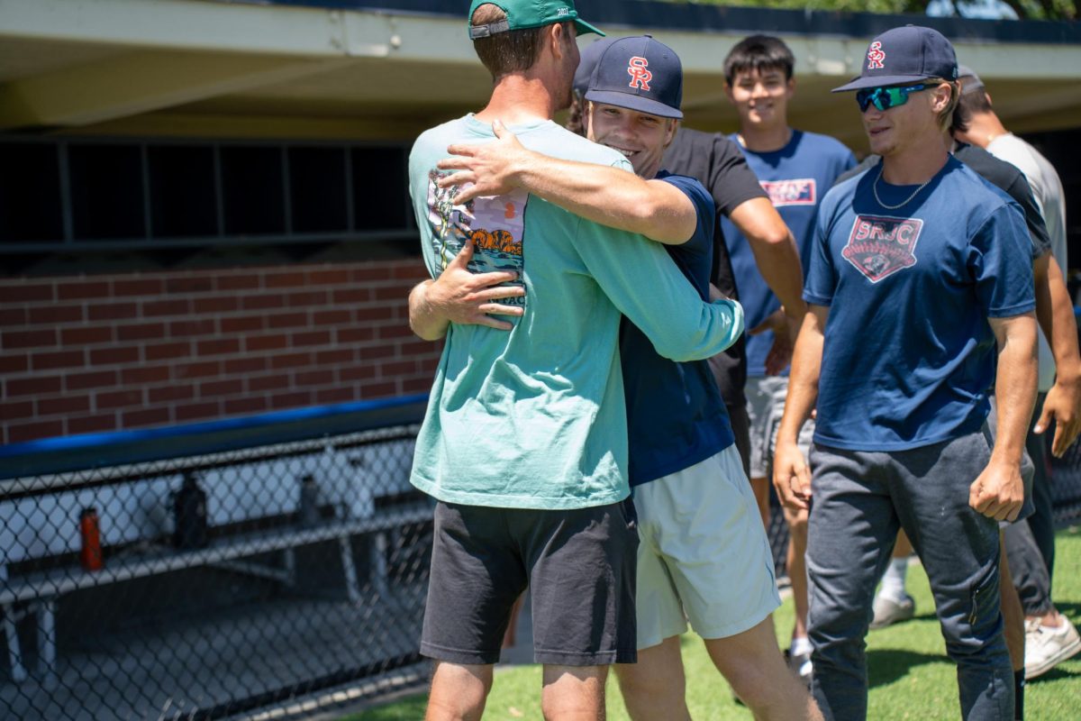 Keenan Morris hugs assistant coach Jared Noonan in the last moments of their final meeting of the season at Santa Rosa's Cook Sypher Field on Tuesday, May 14, 2024.