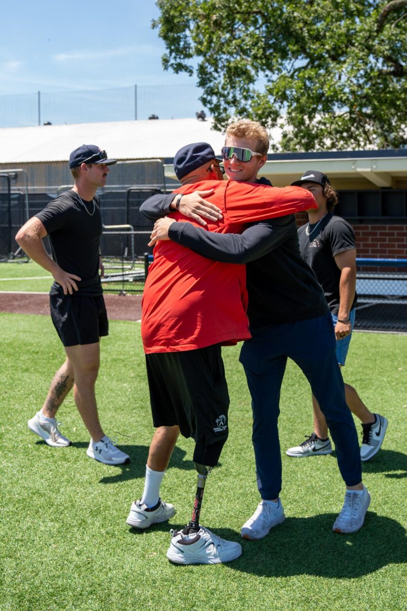 Aidan Lombardi goes in for the hug with assistant coach Tom Francois during the final meeting of the season at Santa Rosa's Cook Sypher Field on Tuesday, May 14, 2024.