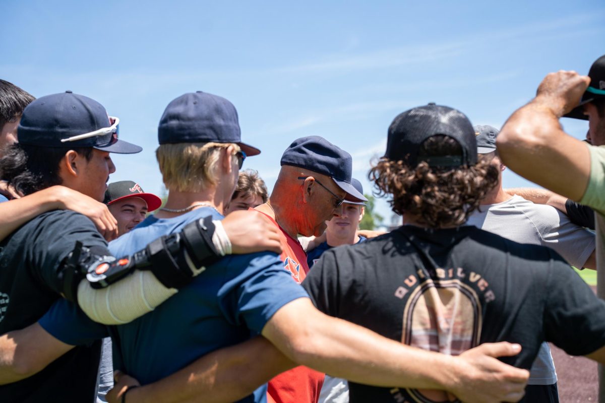 Assistant coach Tom Francois brings the boys in for huddle one final time at Santa Rosa's Cook Sypher Field on Tuesday, May 14, 2024.