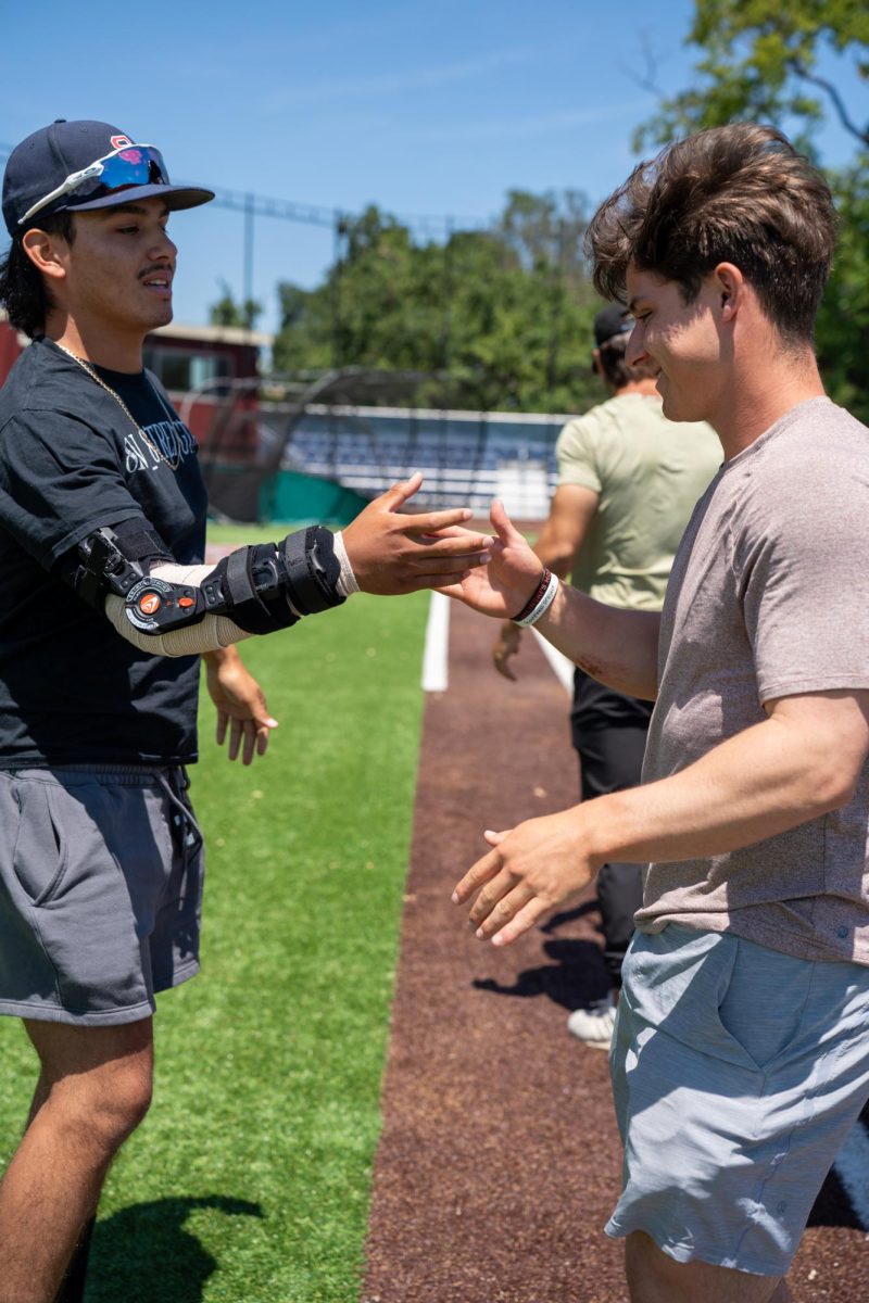 Tony Suarez, left, and Alex Leopard shake hands during the final meeting of the season at Santa Rosa's Cook Sypher Field on Tuesday, May 14, 2024.