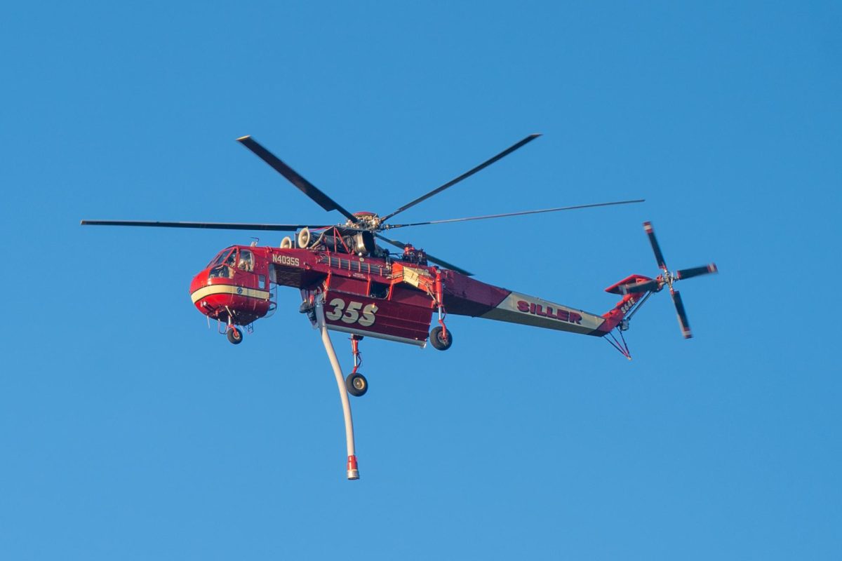 A Siller Aviation Helitanker 35S flies over the Point Fire in Dry Creek Valley on Sunday, June 16, 2024.