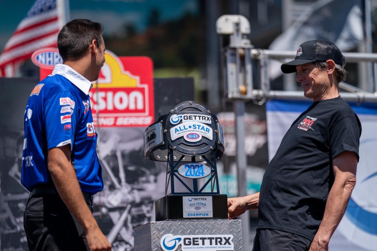 NHRA Pro Stock Motorcycle driver Steve Johnson, right, admires the GETTRX NHRA All-Star Pro Stock Motorcycle Callout trophy belt at Sonoma Raceway on Friday, July 26, 2024 in Sonoma
