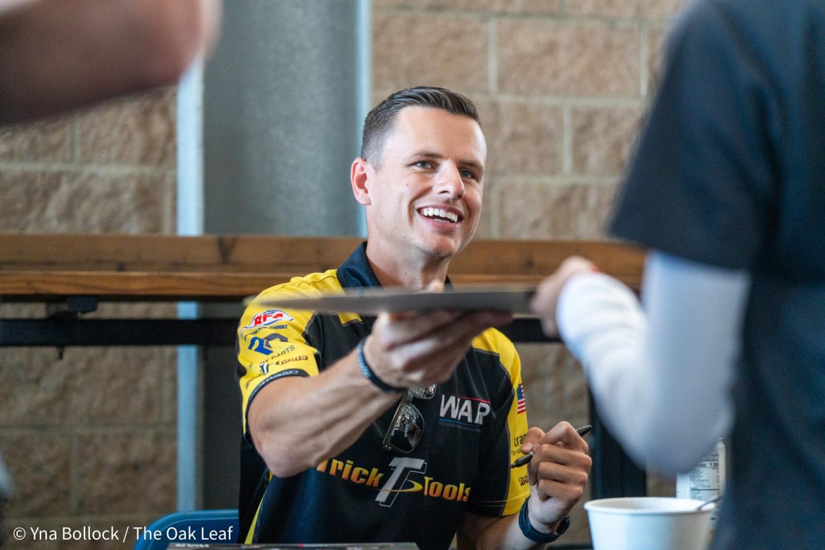 Pro Stock Motorcycle driver Chase Van Sant autographs a sign at the DENSO NHRA Sonoma Nationals on Friday, July 26, 2024 in Sonoma.