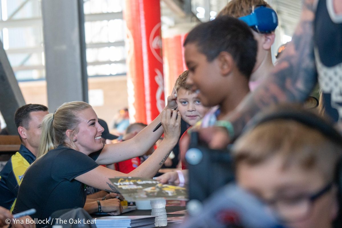 Top Fuel driver Ida Zetterstrom autographs a fan's face at the DENSO NHRA Sonoma Nationals on Friday, July 26, 2024 in Sonoma.