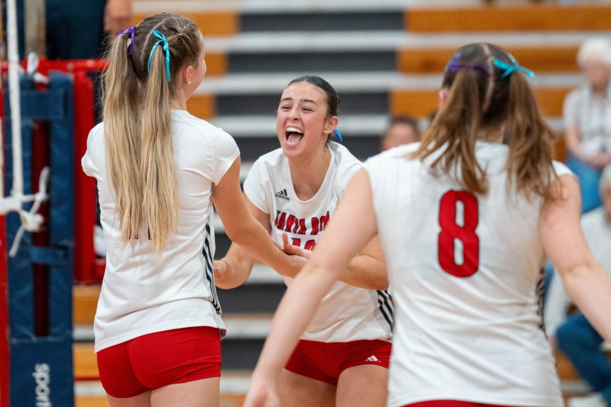 Kiana Walker left, Lily Comma center, and Katie Brenninger right, celebrate together after a hard fought point against Cosumnes River on Wednesday, Sept. 18, 2024