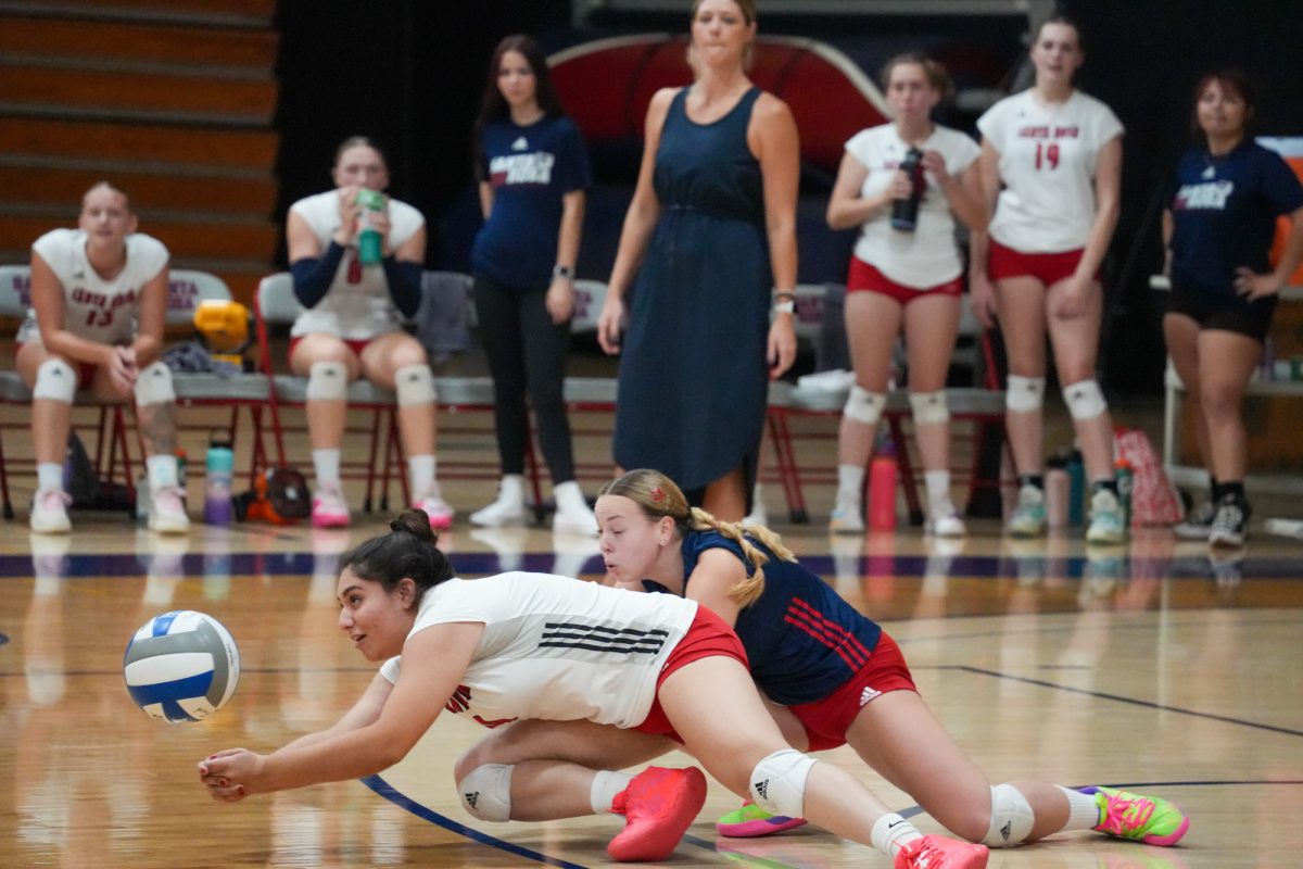Santa Rosa’s outside hitter Stephanie Melendez, along with defensive specialist Jaiden Brooner, drop down for a dig against Folsom Lake on Friday, September 27, 2024. 
