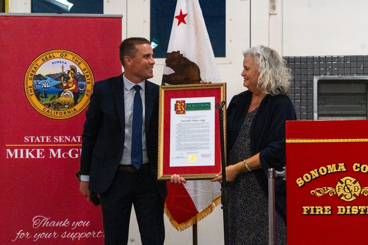 State Senator Mike McGuire hands former Mayor Deborah Fudge an award for her services to Windsor during his Town Hall Meeting at the Sonoma County Fire District Station No. 3 on Oct. 17, 2024.