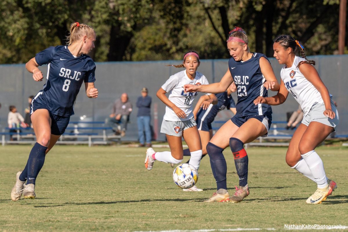 Bear Cubs’ forward Shae Dougherty holds up the ball as forward Taylor Gandy makes an overlapping run against Cosumnes River at home on Tuesday, Oct. 29, 2024.