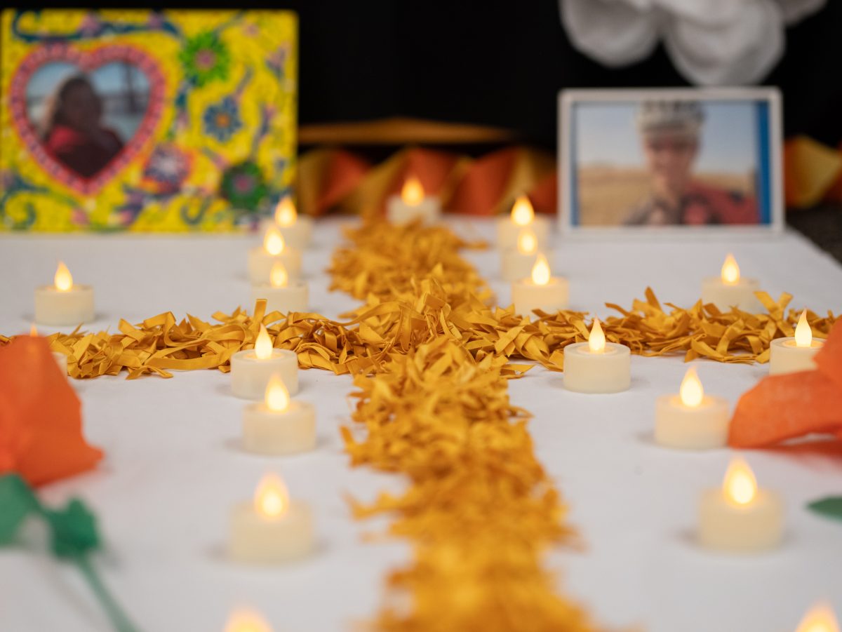 An ofrenda placed inside of the Tutor Center is visited during the procession at the Dia De Muertos celebration at the Bertolini Student Center on Wednesday, Oct. 23, 2024.