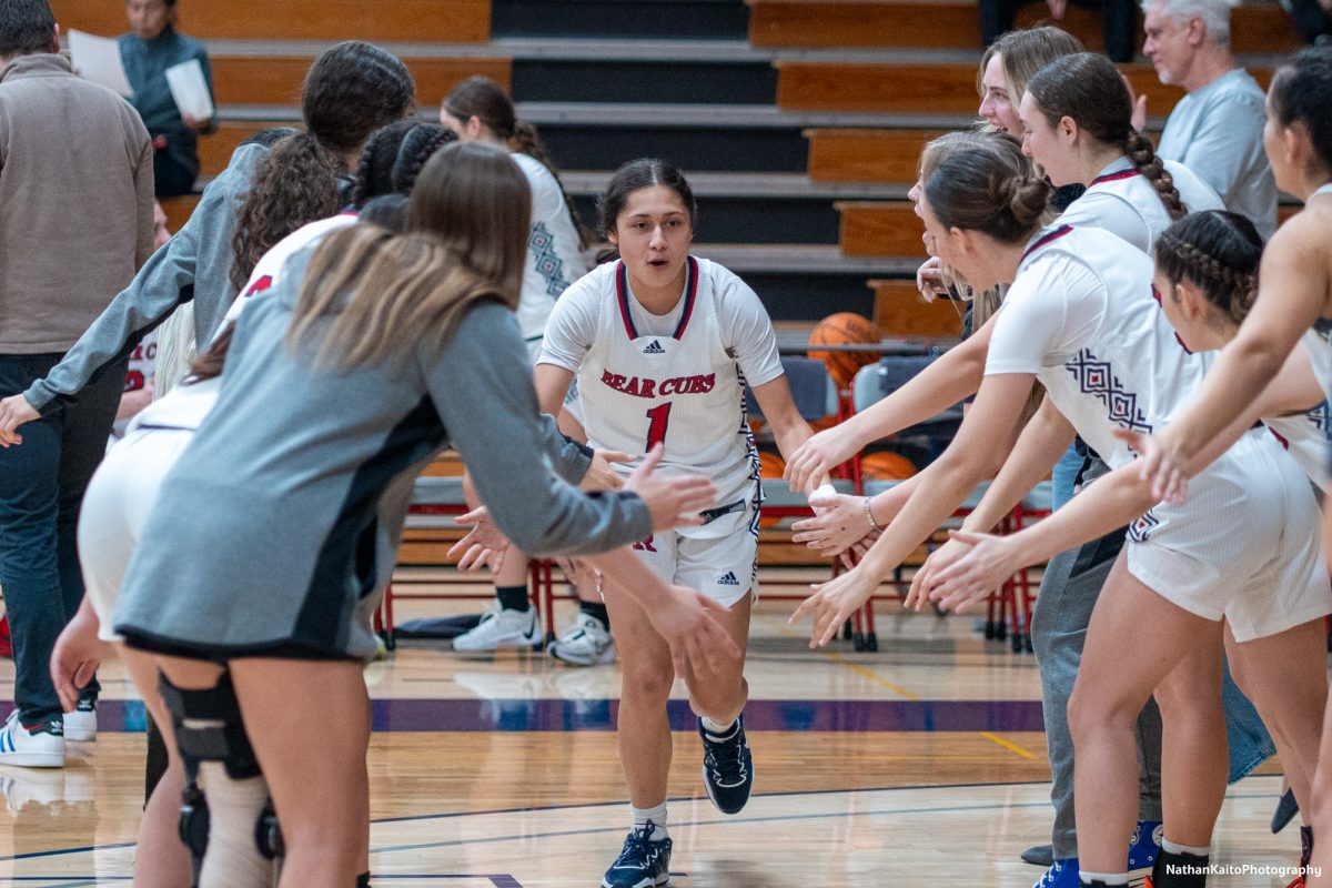 Bear Cubs’ guard Lindsey Arellano runs through and high-fives her teammates as anticipation builds for their game against Butte at Haehl Pavilion on Tuesday, Dec. 10, 2024