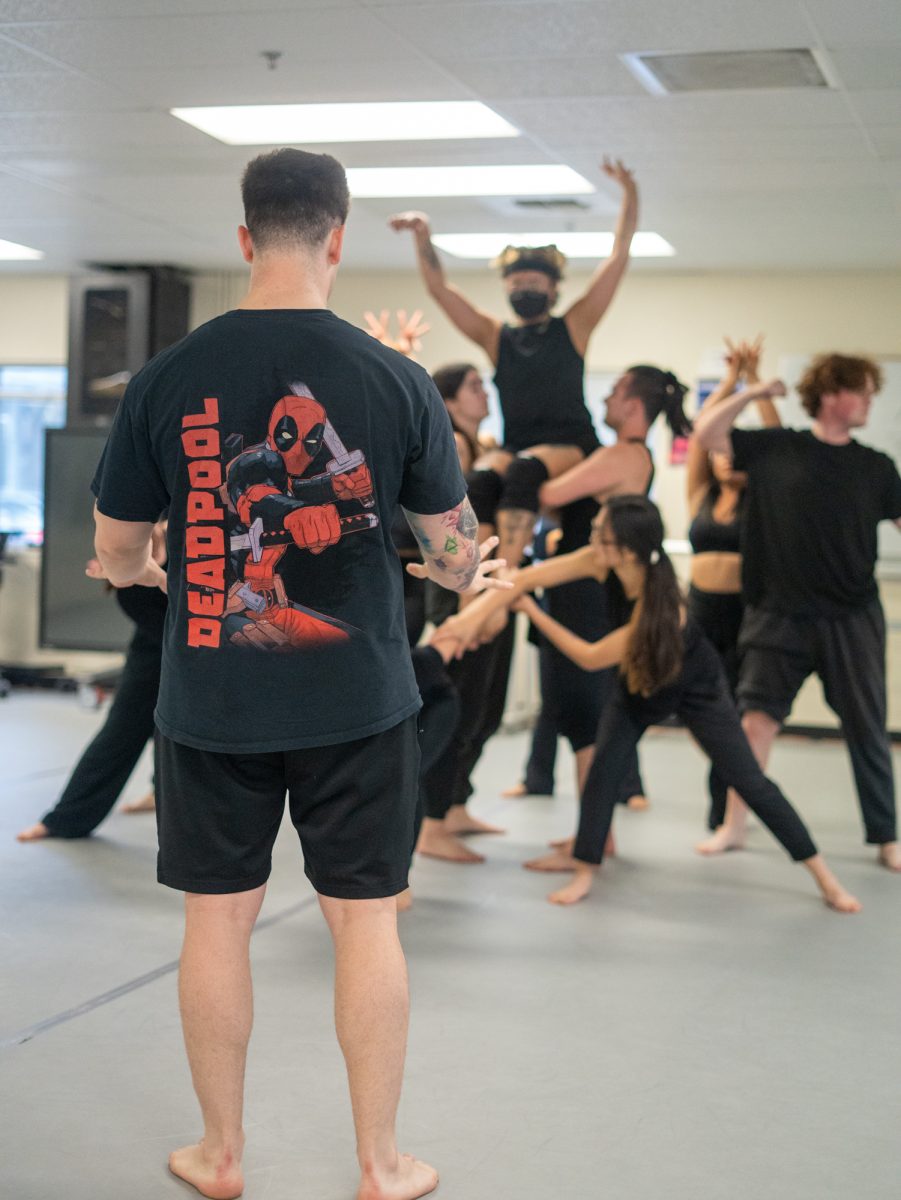 Choreographer Simeon Van Izquierdo goes over a stunt in his piece with student dancers in the Analy Village dance studio in Fall 2024.