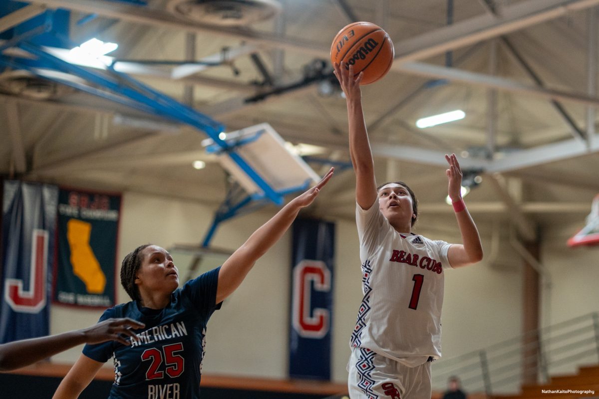 Bear Cubs' guard Lindsey Arellano reaches higher than the Beaver's forard, Areyana Francies as she goes for a lay-up at Haehl Pavilion on Friday, Feb. 21, 2025.