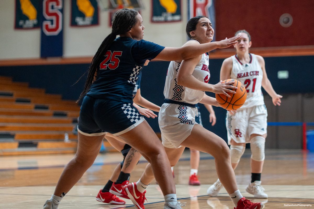 SRJC's forward Cece Solano shields the ball from American River's Areyana Francies as she looks to add to the Bear Cubs' advantage at Haehl Pavilion on Friday, Feb. 21, 2025.