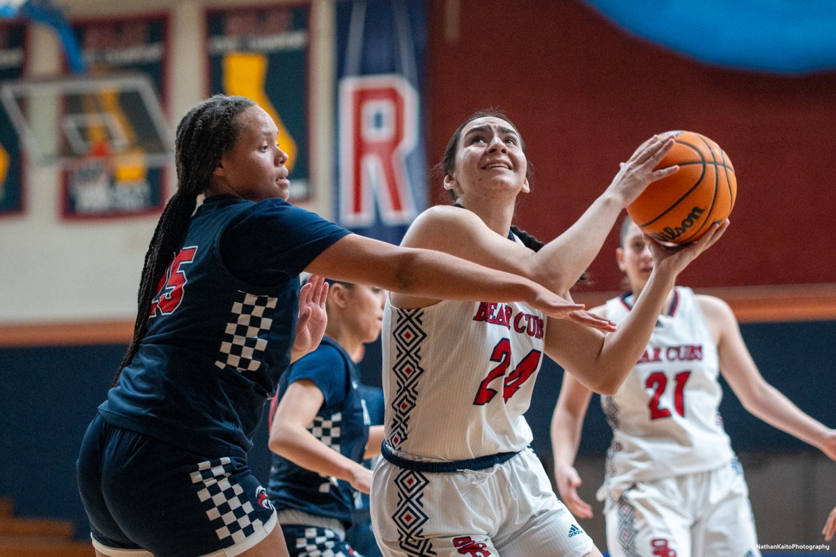 Bear Cubs' forward Cece Solano shields the ball and goes up for a lay-up against American River at Haehl Pavilion on Friday, Feb. 21, 2025.