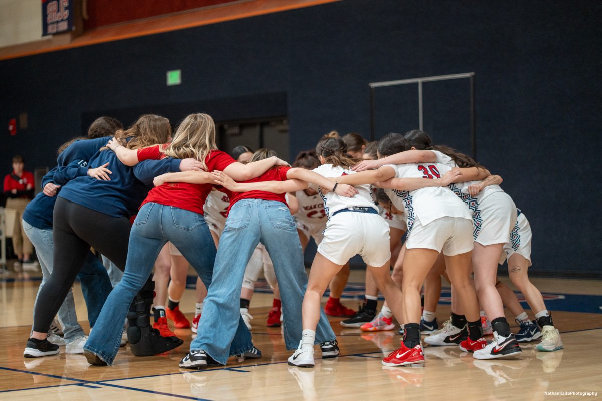 The Bear Cubs huddles together and chants as they hype each other up as they prepare to take on American River at Haehl Pavilion on Friday, Feb. 21, 2025.