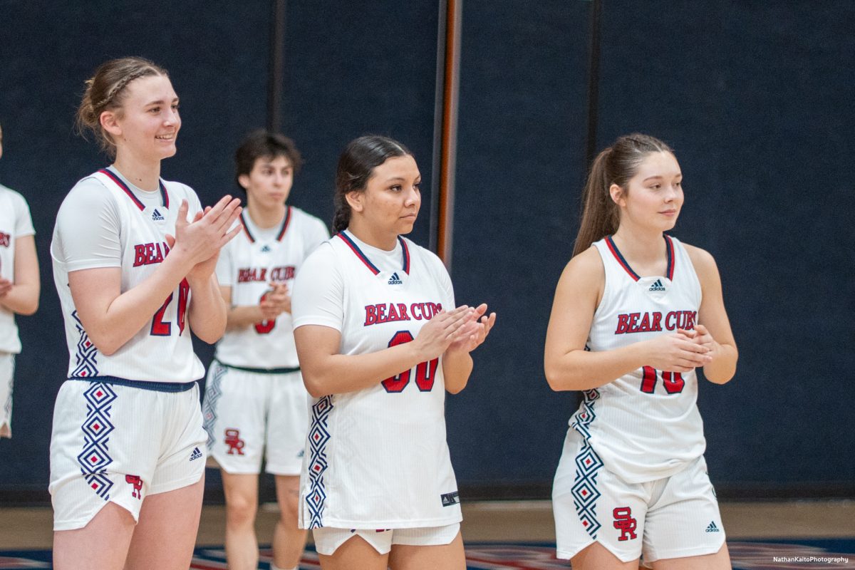 Left, Sydney Martin, center, Betzie Hernandez, and right, Shasta Vlasak gives the sophomores a round of applause before their game against American River at Haehl Pavilion on Friday, Feb. 21, 2025.