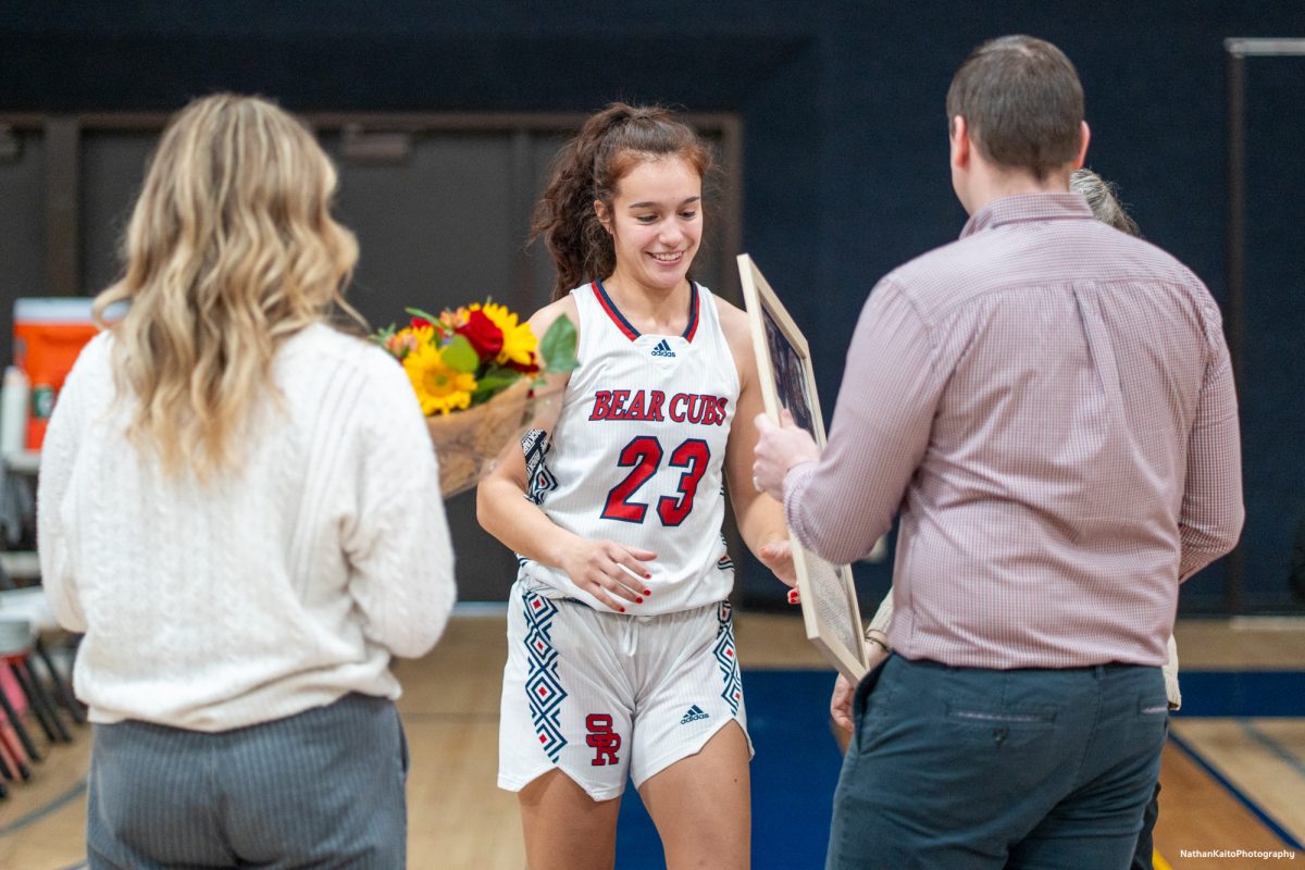 Bear Cubs' coaching staff gives guard, Ivy Gonzalez a bouqet of flowers and framed photo with memories from the season in recognition of the two seasons she played at SRJC before their game against American River at Haehl Pavilion on Friday, Feb. 21, 2025.