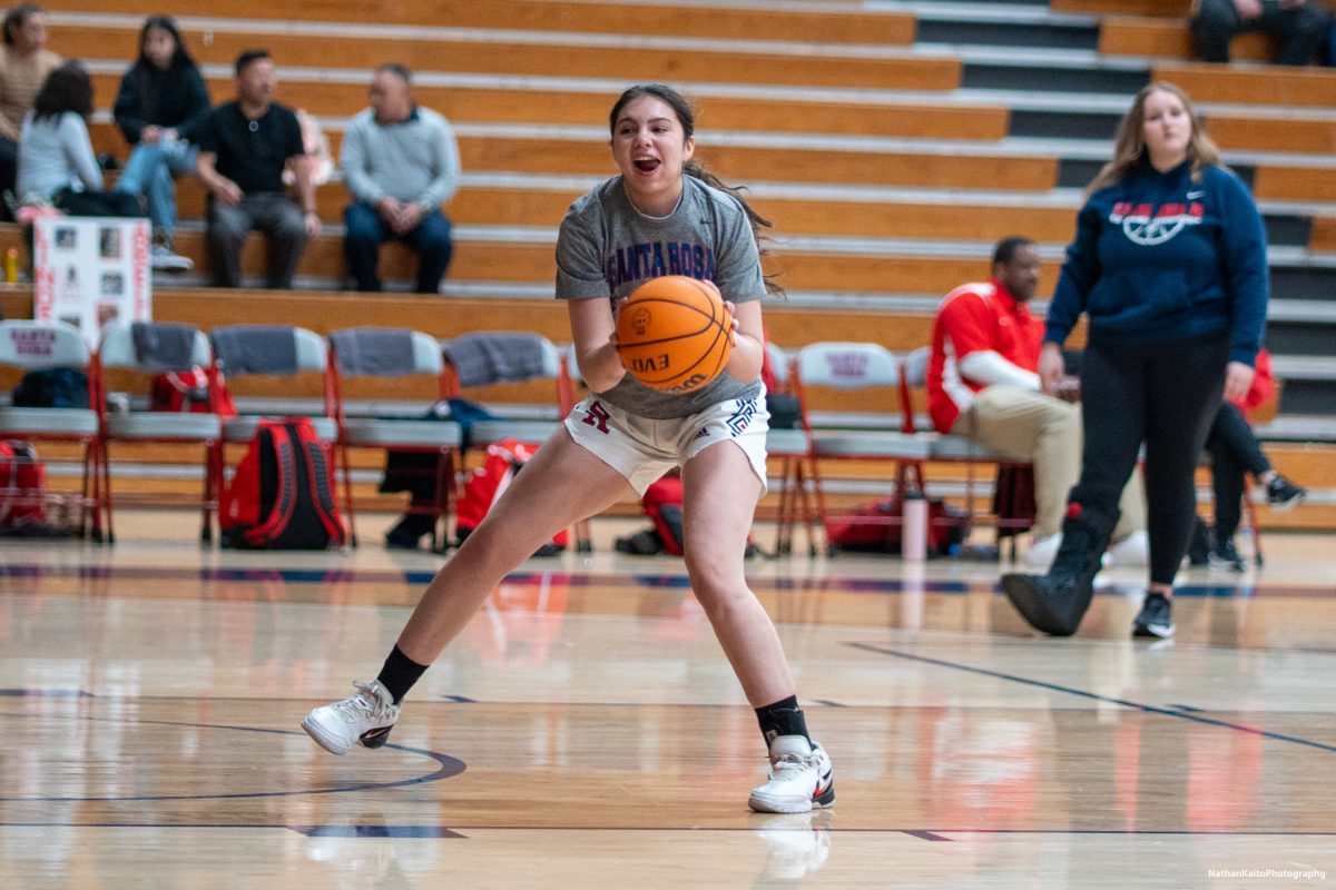 Bear Cubs' forward Natalie Royer warms up with a smile on her face as the team prepare to face American River at Haehl Pavilion on Friday, Feb. 21, 2025.