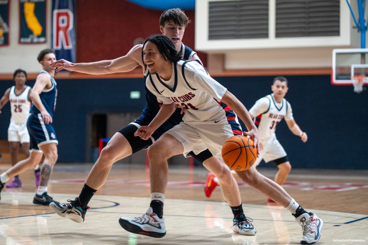 SRJC's Tayden Collins laughs while tries to go to the rim, as the bench urges him to shoot against American River at Haehl Pavilion on Friday, Feb. 21, 2025.