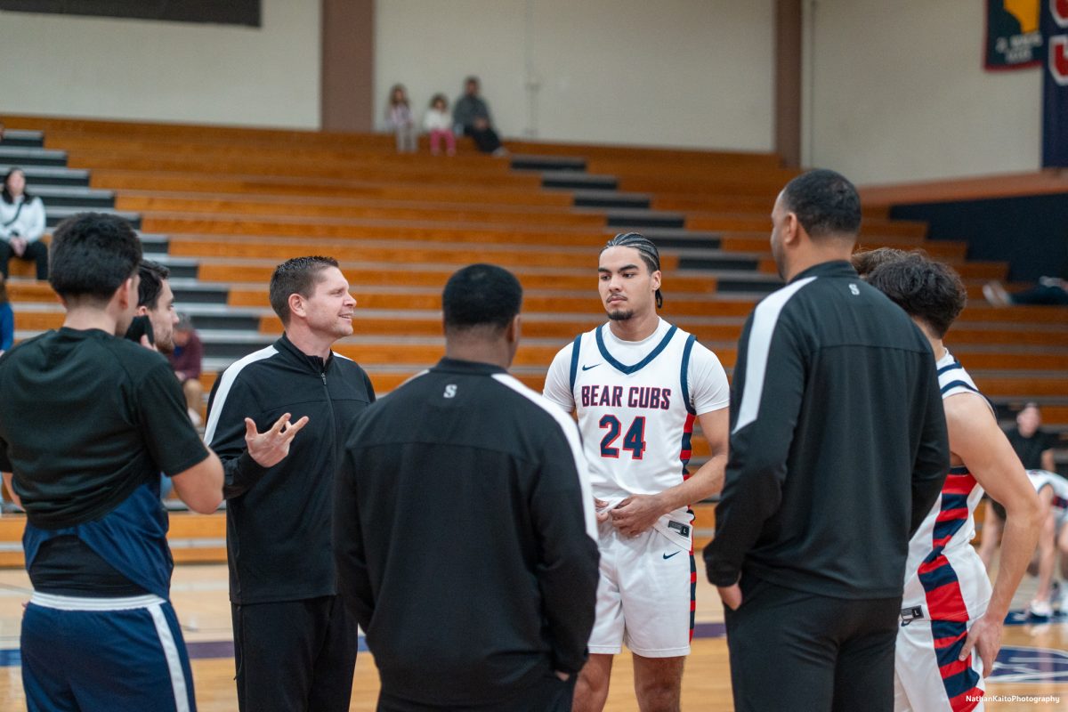 Bear Cubs' forward Vincent Jackson and the rest of the captains speaks to the refrees and American River's captans as the anticipation builds in Haehl Pavilion on Friday, Feb. 21, 2025.