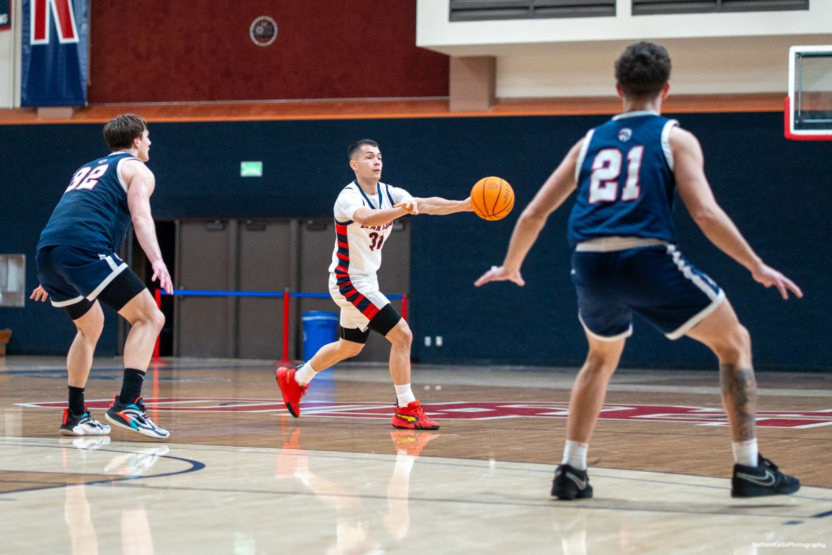 Bear Cubs' guard Kobe Gatti passes the ball as they look to orchestrate an attack against American River at Haehl Pavilion on Friday, Feb. 21, 2025.