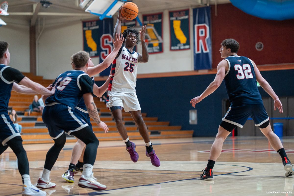 SRJC's guard Gavin Cook-Whisenton passes the ball while surrounded by American River's players at Haehl Pavilion on Friday, Feb. 21, 2025.