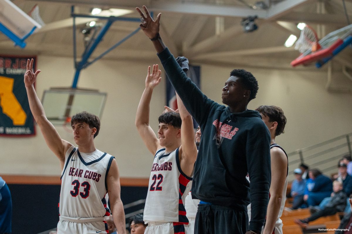 The Bear Cubs' bench celebrates a Kobe Gatti three pointer against American River at Haehl Pavilion on Friday, Feb. 21, 2025.