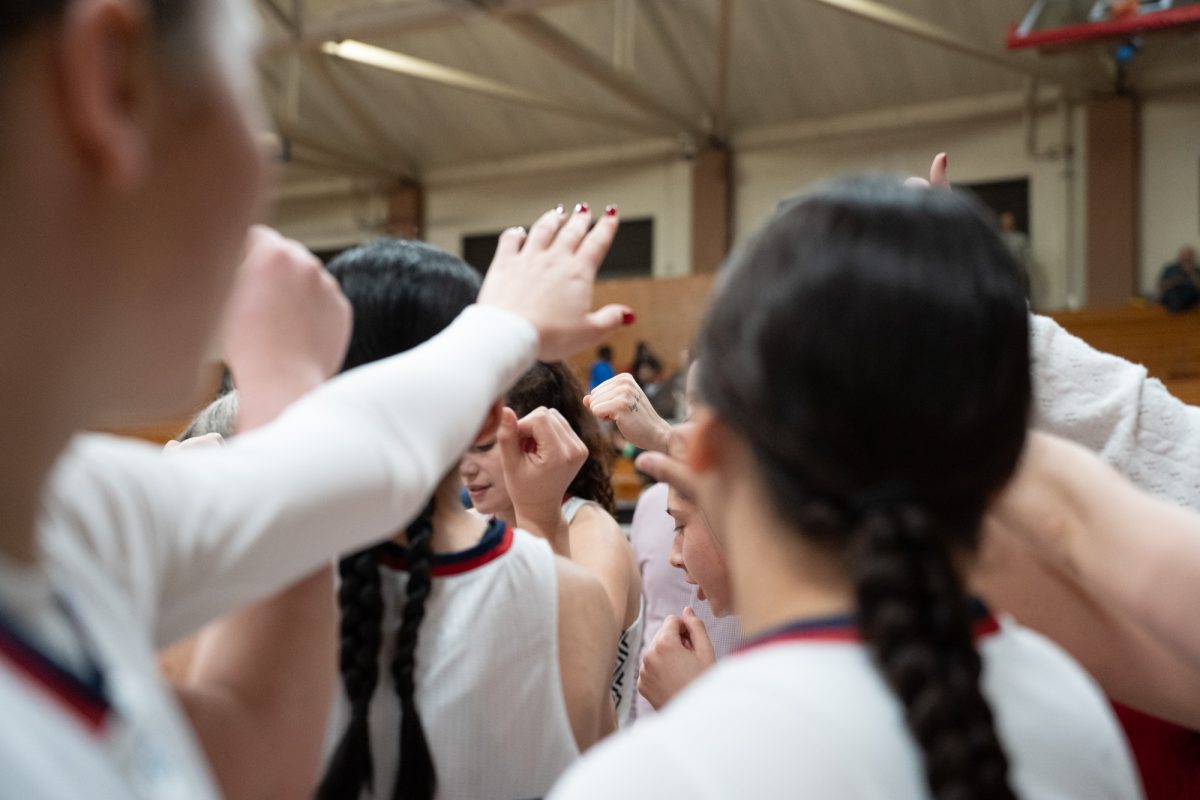 The Bear Cubs raise their fists after a huddle to preapre themselves for their match against American River College at Haehl Pavilion on Friday, Feb. 21, 2025.
