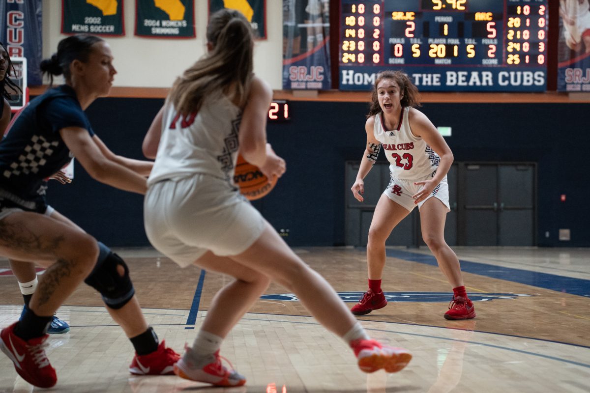 Bear Cubs guard Shasta Vlasak, left, looks to pass to guard Ivy Gonzalez, right, during their match against American River College at Haehl Pavilion on Friday, Feb. 21, 2025.