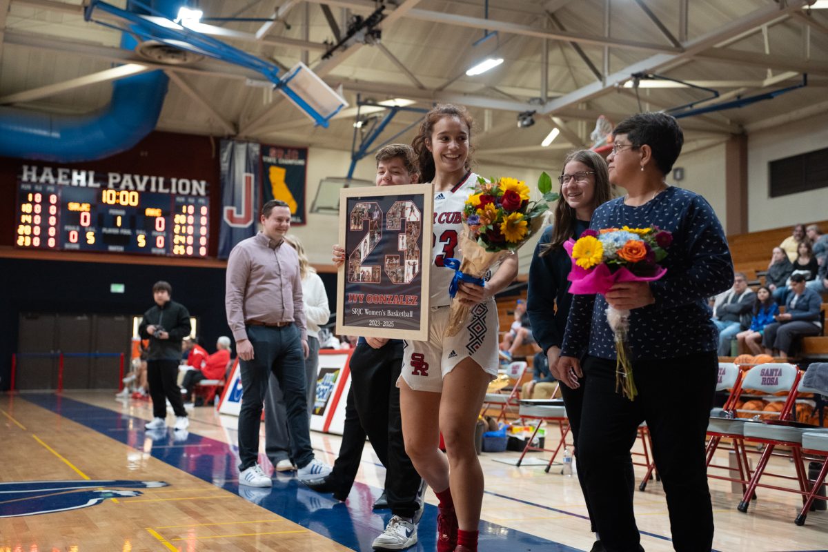 Bear Cubs guard Ivy Gonzalez walks with her family wearing a big smile before her match against American River College on Friday, Feb. 21, 2025.
